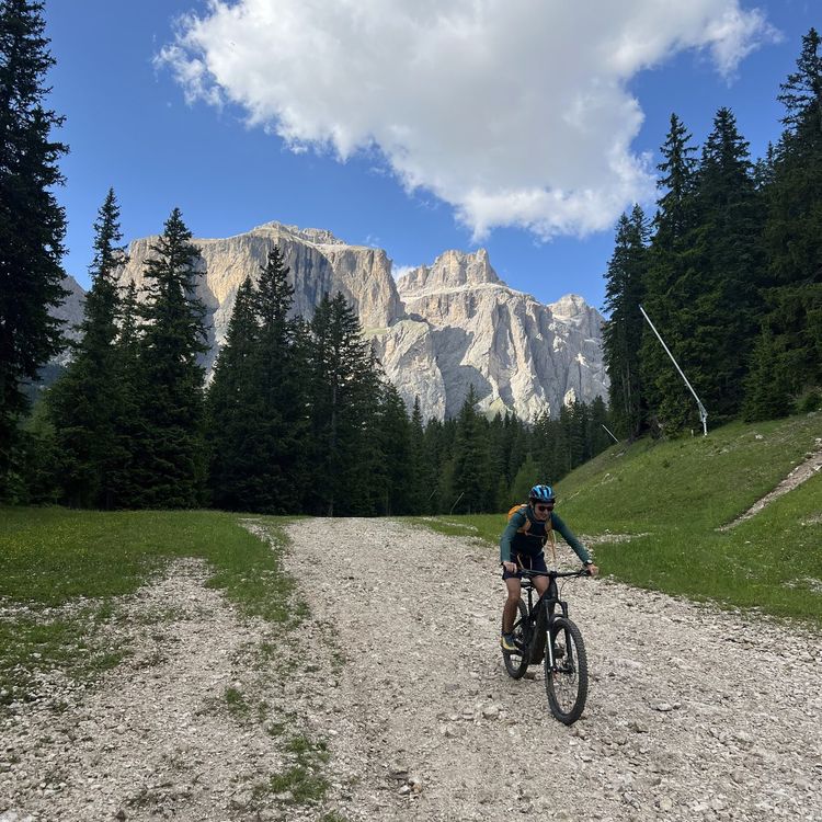 Mountain biker beneath the Sella massif in the Dolomites