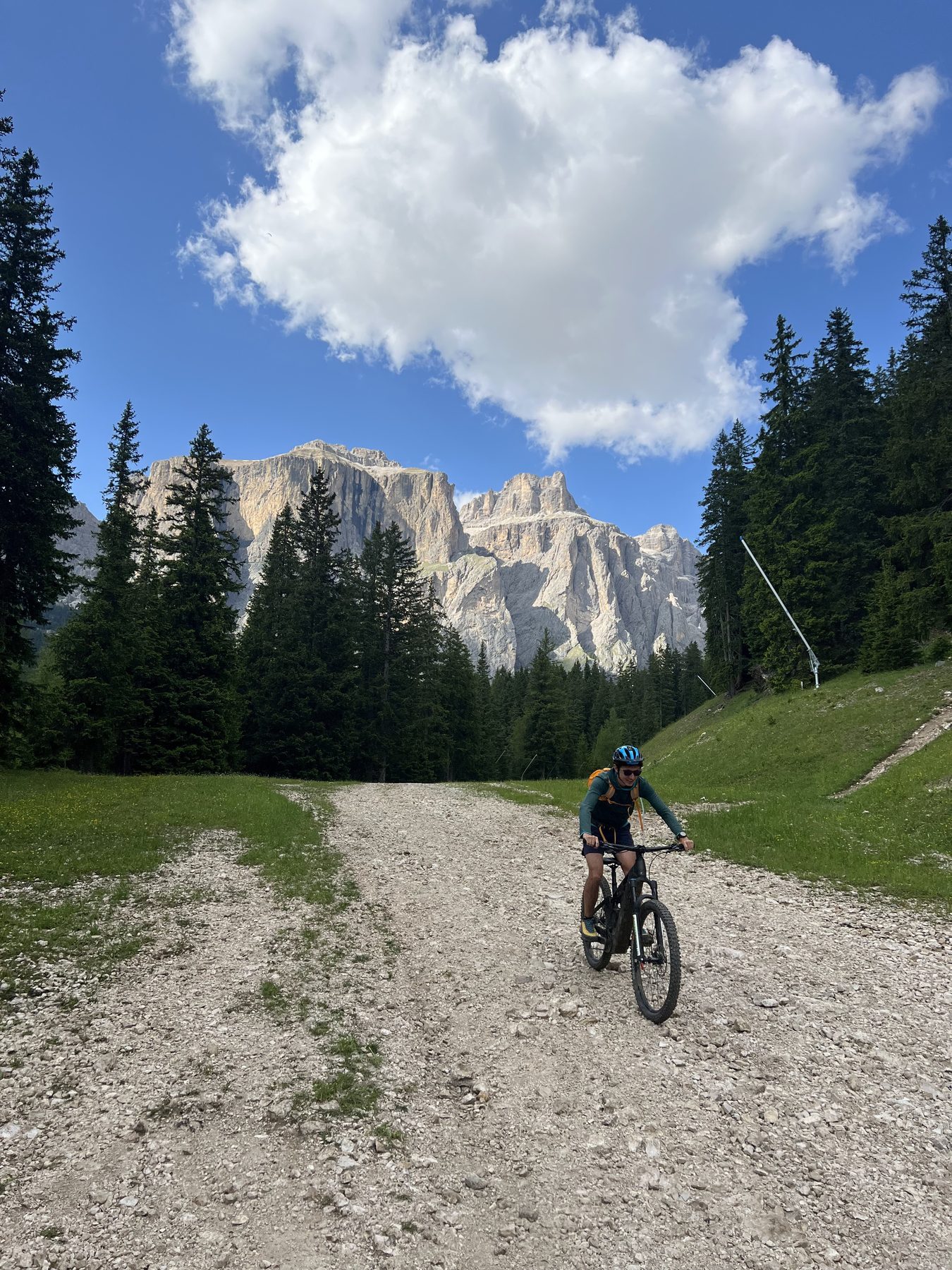 Mountain biker descending beneath the Sella massif