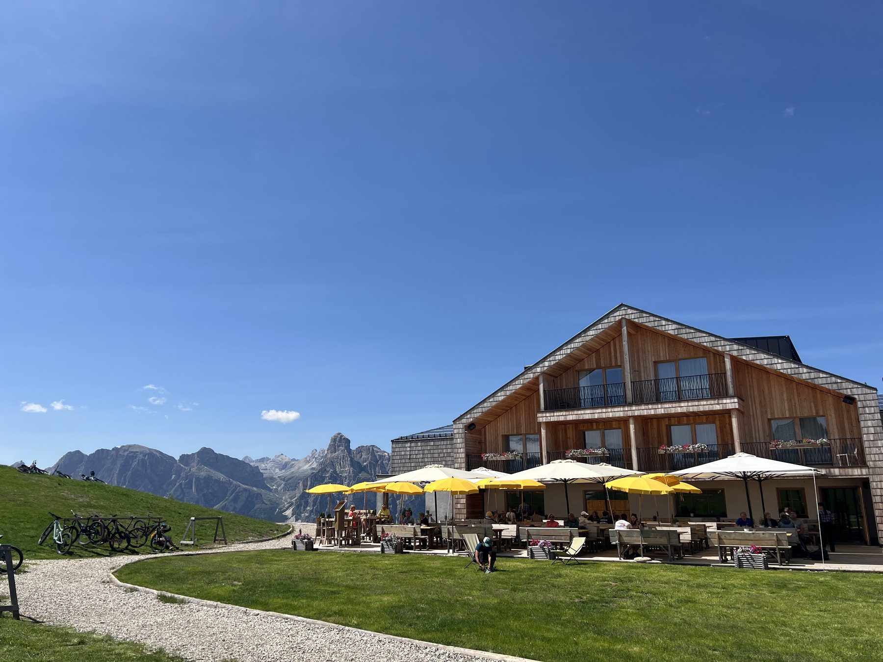 Mountain rifugio with bicycles and yellow umbrellas in the Dolomites