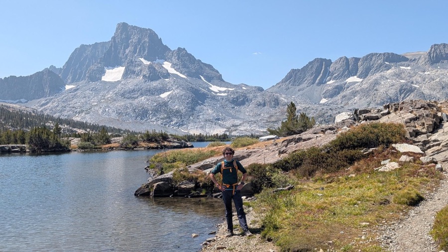Hiker at Thousand Island Lake beneath Banner Peak